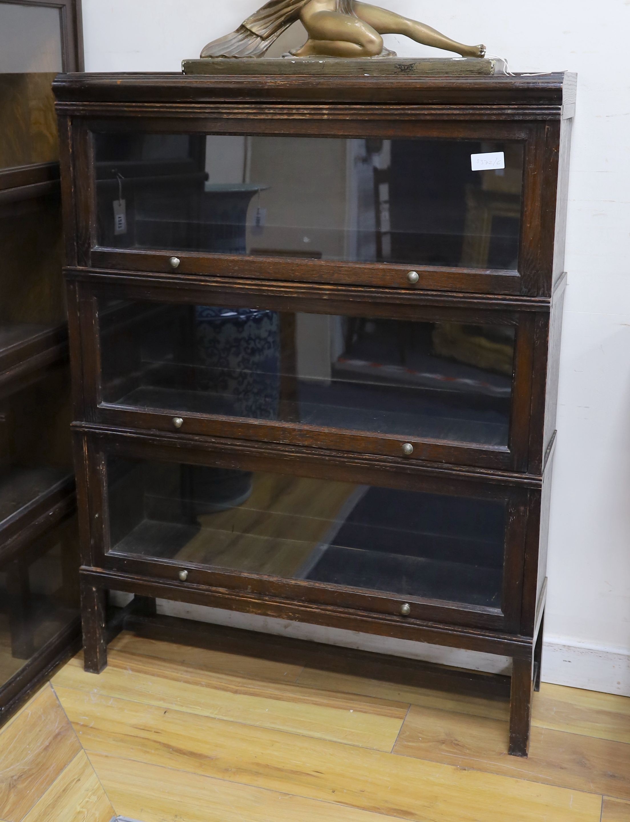 A Globe Wernicke style three section oak bookcase, length 86cm, depth 26cm, height 116cm